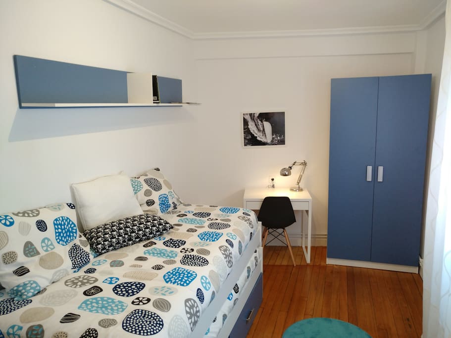 Dormitorio con cama nido y zona de trabajo