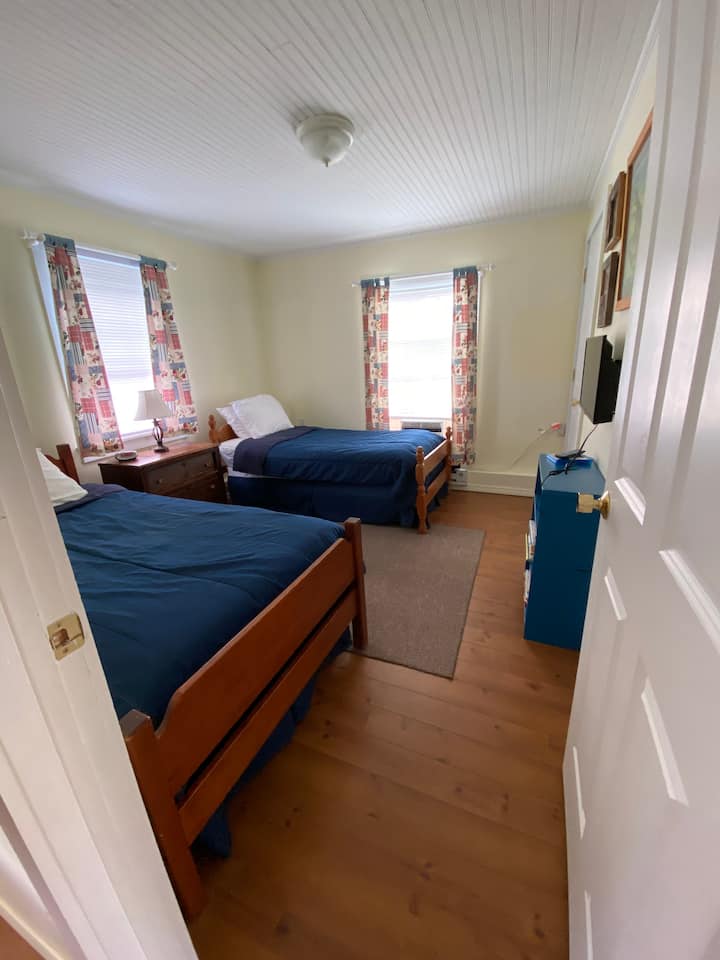 One bedroom with twin size beds. Window unit air conditioning included. 