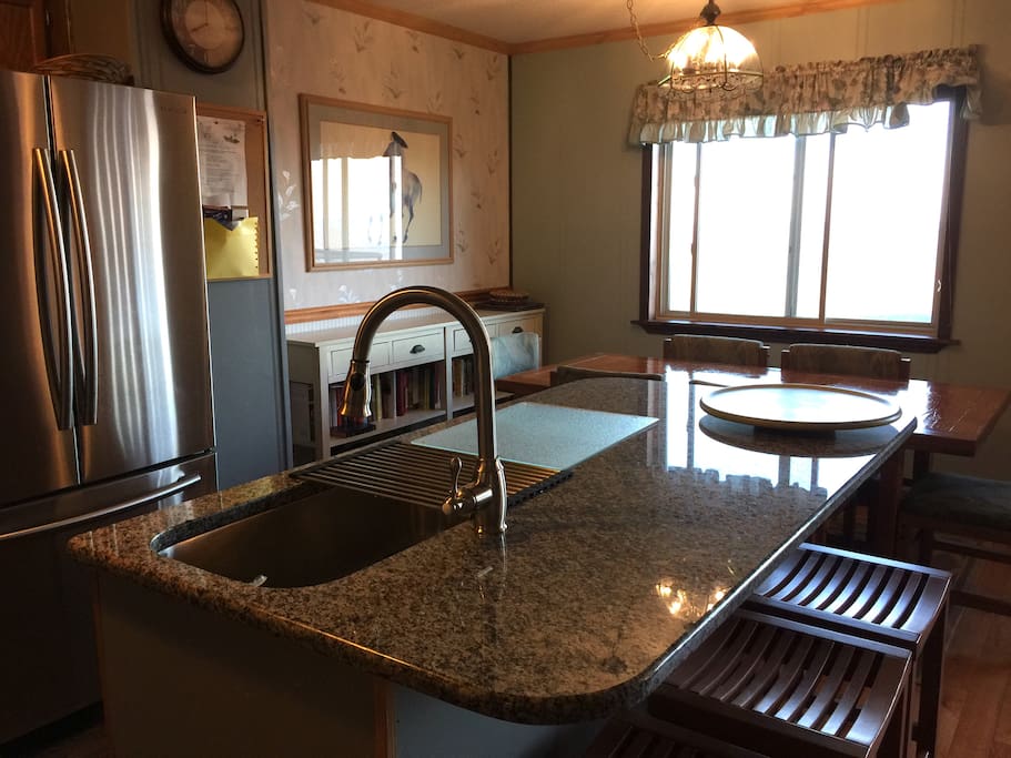 A granite counter with space for laptops or eating! The sink is huge!