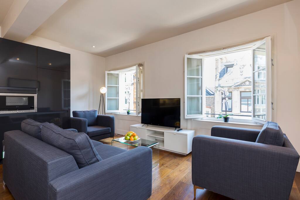 The living space with two armchairs, a sofa and flat screen TV with British channels