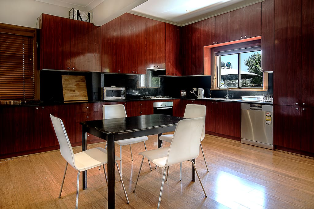 Modern granite top Kitchen Miele gas cooktop oven, dishwasher, crockery available