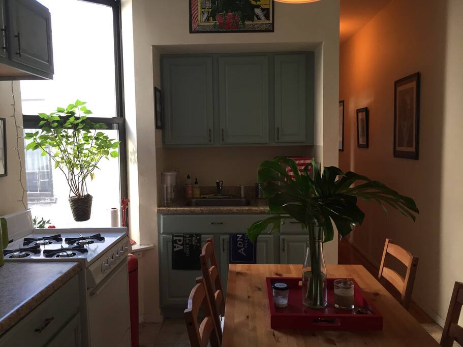 Kitchen with dining table, gas stove and kettle