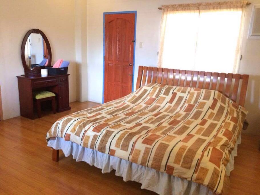 Powder desk and king-size orthopedic bed are inside the spacious room. Sofa bed will be provided for additional guests.