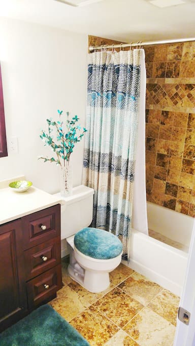 Beautiful full bathroom with clean granite shower