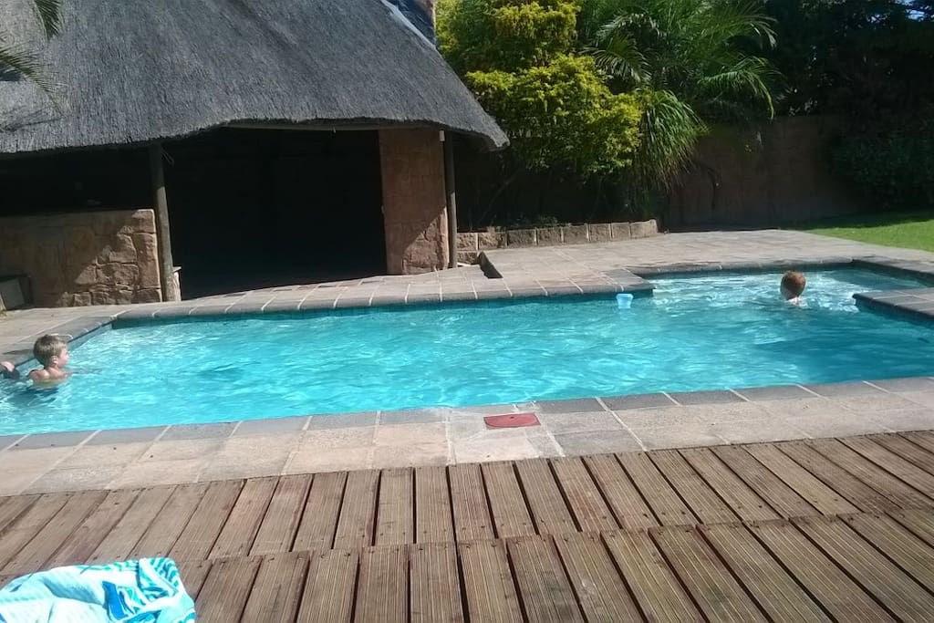 Swimming pool with Thatched lapa, built in braai & bar area with pool table, bar fridge & lights