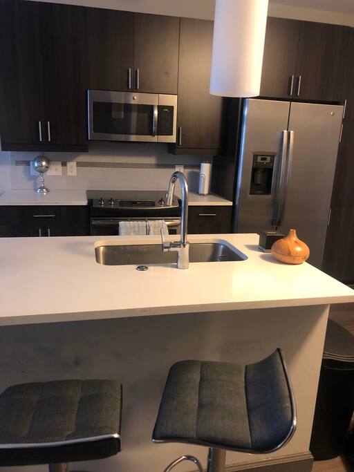 Island barstools and ice maker fridge
