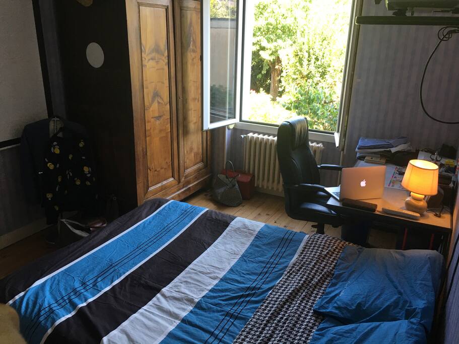 Ici, la chambre mise à disposition. Un lit double, un grand bureau et une vue sur le jardin.