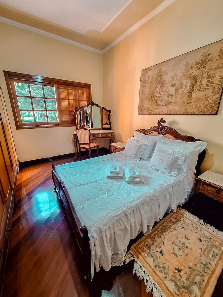 Beautiful double bedroom with comfortable mattress, wardrobe, dresser and baby crib.