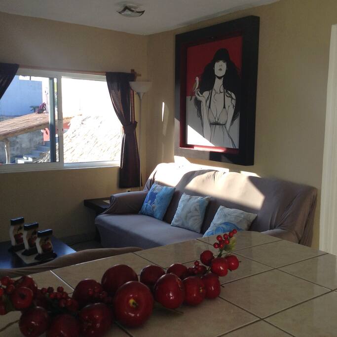 Comfy couches with nice wall hangings.