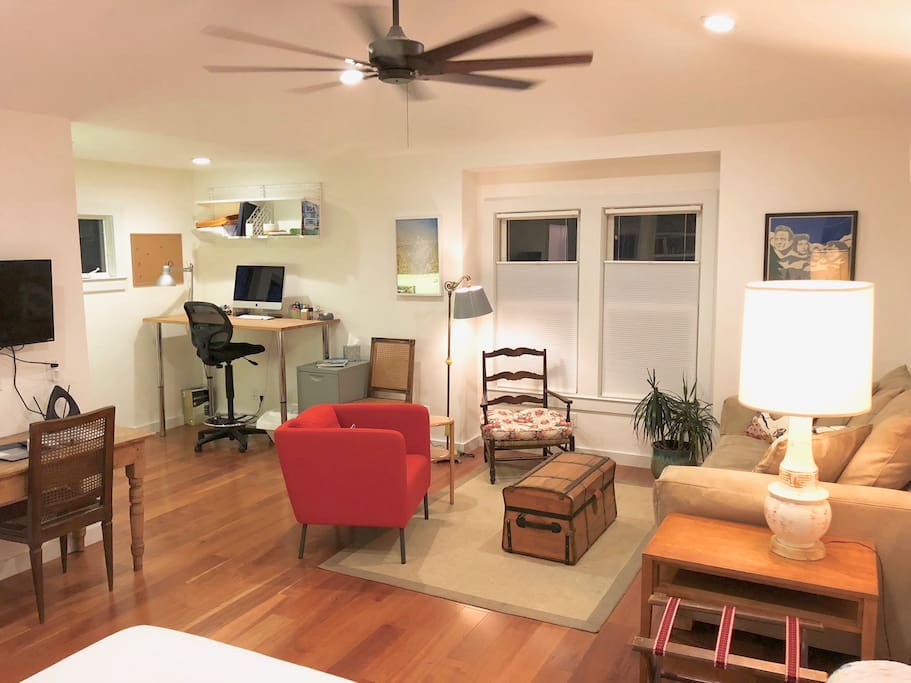 Evening view of living space with stand-up computer desk.