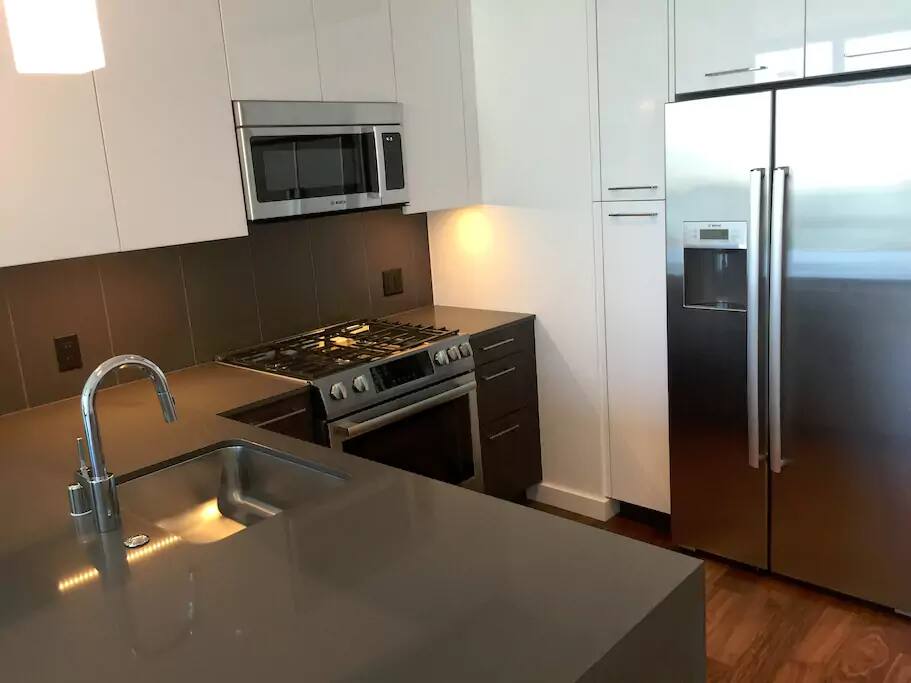 Clean, Inviting kitchen complete with Plates, Silverware, etc