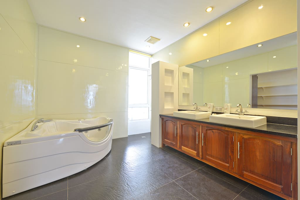 Modern spacious master bathroom with jacuzzi and his & hers sinks
