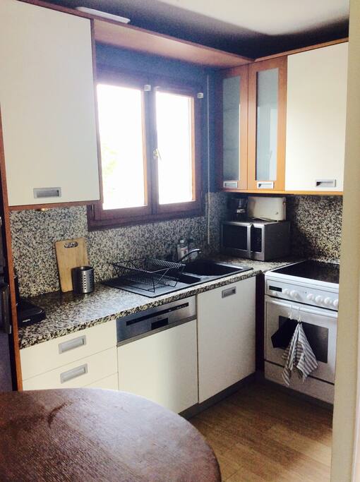 The kitchen, small but functional, opened on the lounge.