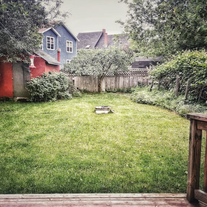 A cozy backyard complete with fruit trees, a BBQ, fire pit and a lovely patio!