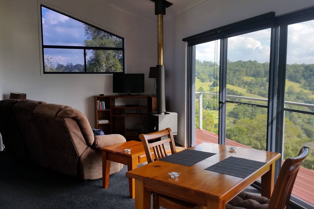 The lounge and dining area showing wood fire and view.