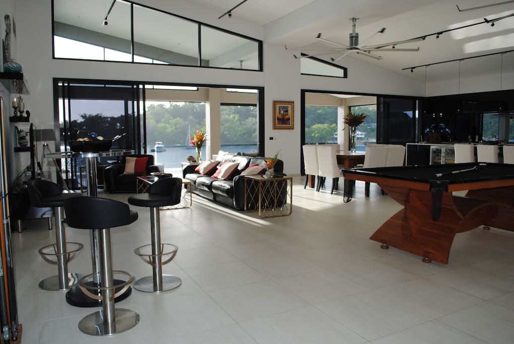 Onyx Vanuatu Harbour Resort Residence Pandanus Penthouse - Open floor plan with dining, kitchen, living & entertaining areas opening onto veranda overlooking Port Vila Harbour
