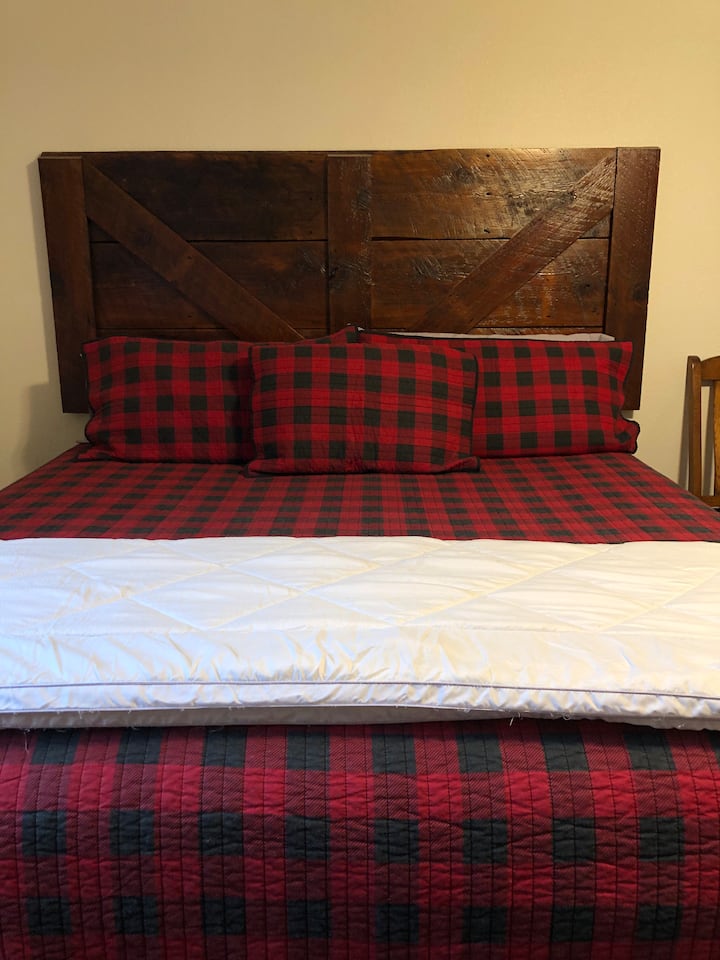 This is a king bed that is in one of the rooms in the top of the bunkhouse.