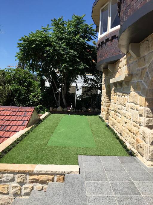 Putting green at your doorstep with balls and putters.