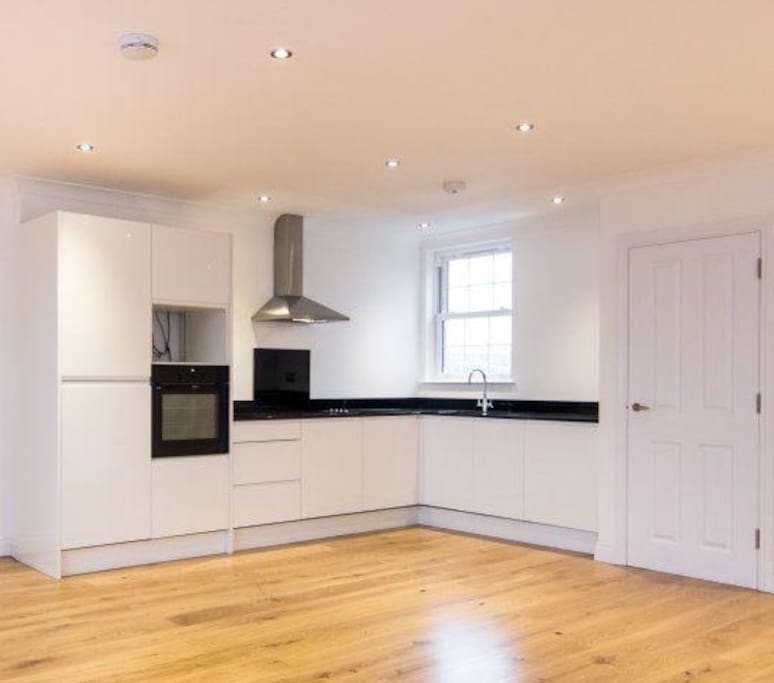 Clean, modern kitchen with built in appliances (including dish washer and washing machine)