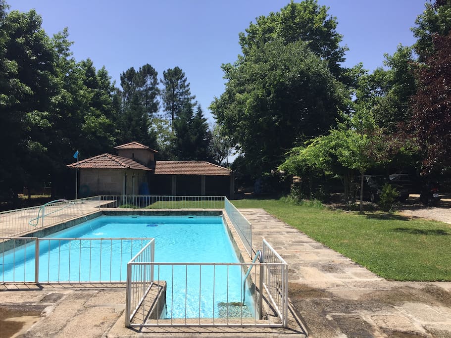 Pool with movable 60 cm metal fence children protection and exterior rural kitchen in the background