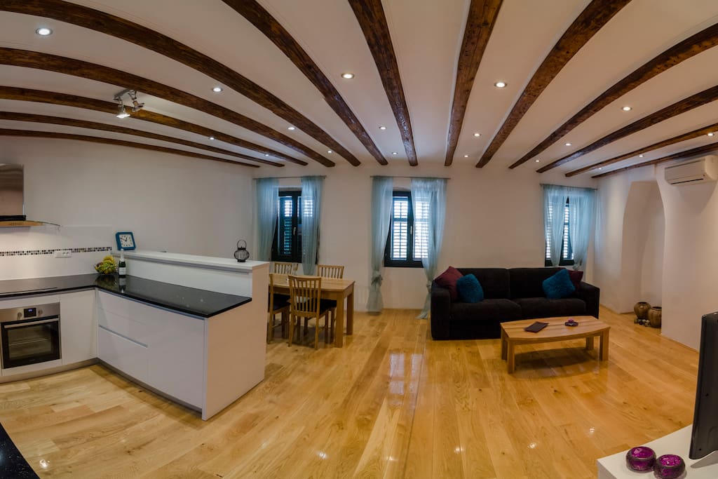 Spacious open plan living area with sea views when shutters opened!