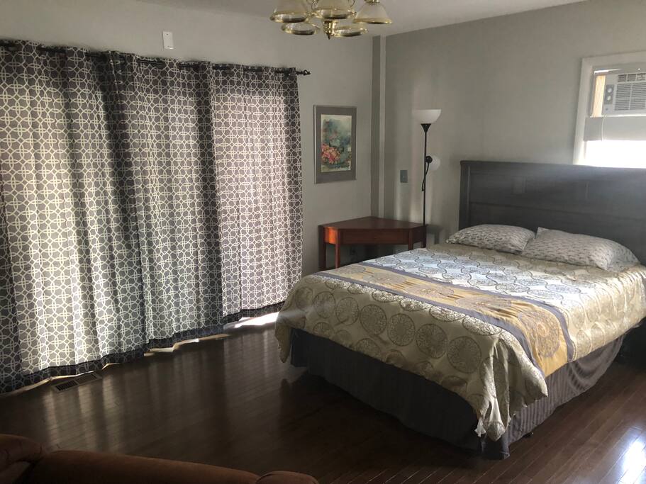 Queen size bed with bathroom, kitchen and sun porch connected