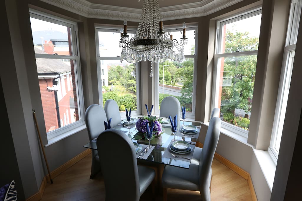 the dining table is in the bay set for 6 people (will sit 8)