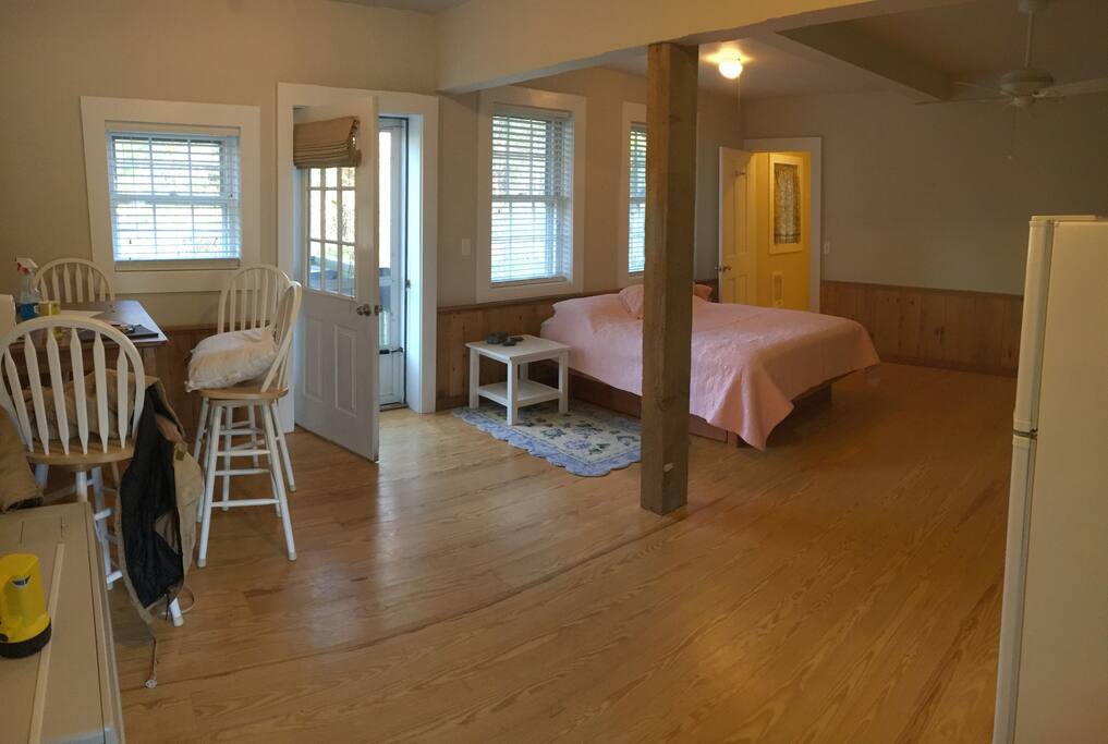 Eating area to the left and Queen Sized bed to the right.
