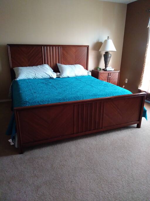 Second bedroom with Cali king size bed facing with a view to driveway.