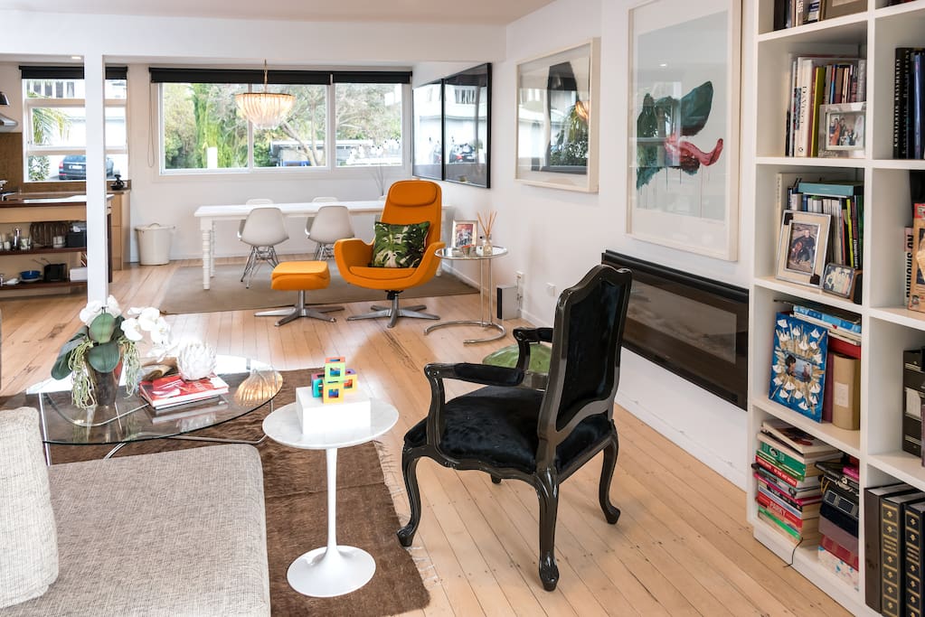 Open plan living area with fireplace. TV on trolley so it can move.