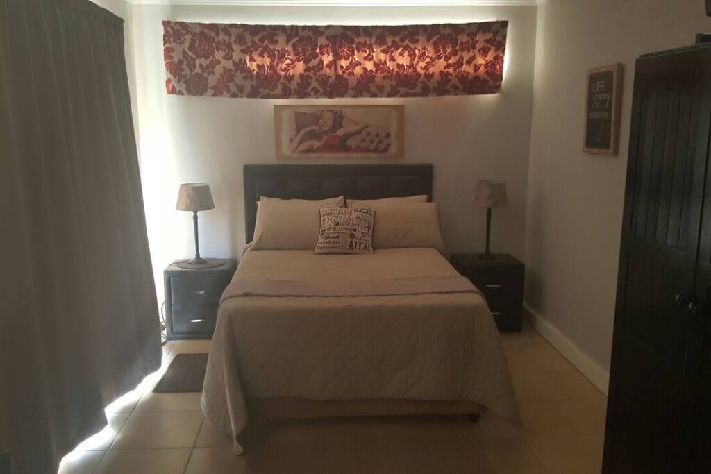 Queen size bed, with fan and heater close by. DSTV/SABC