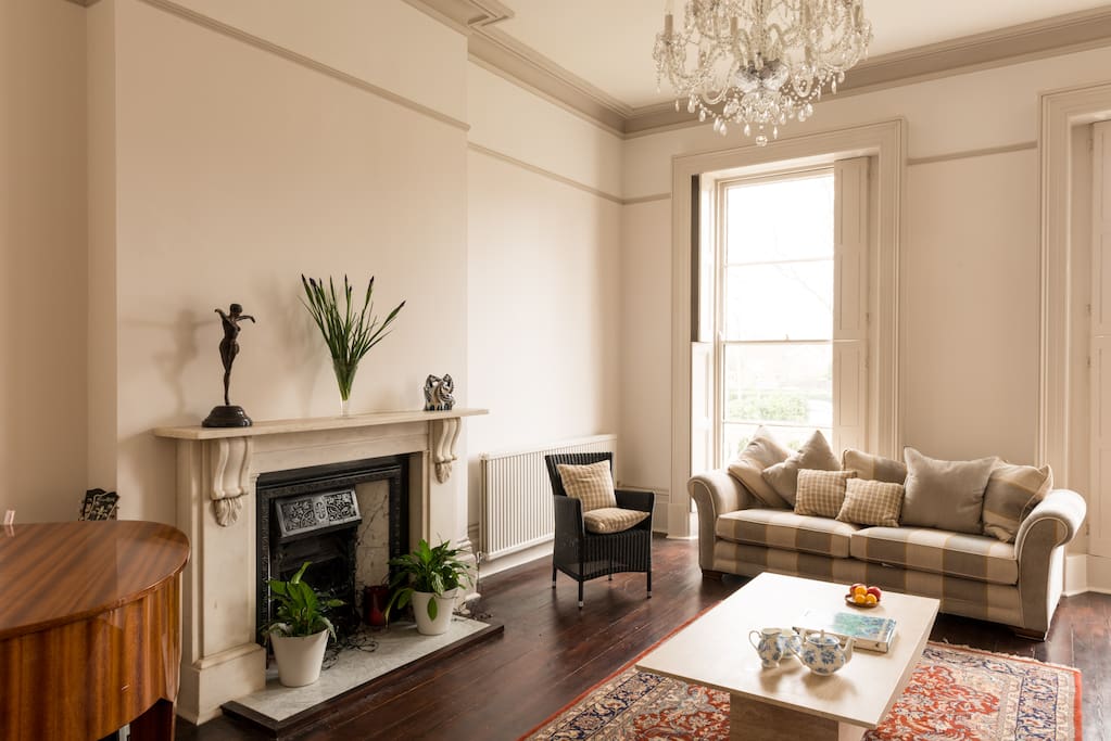 Large drawing room with piano to relax after a day of racing or being out