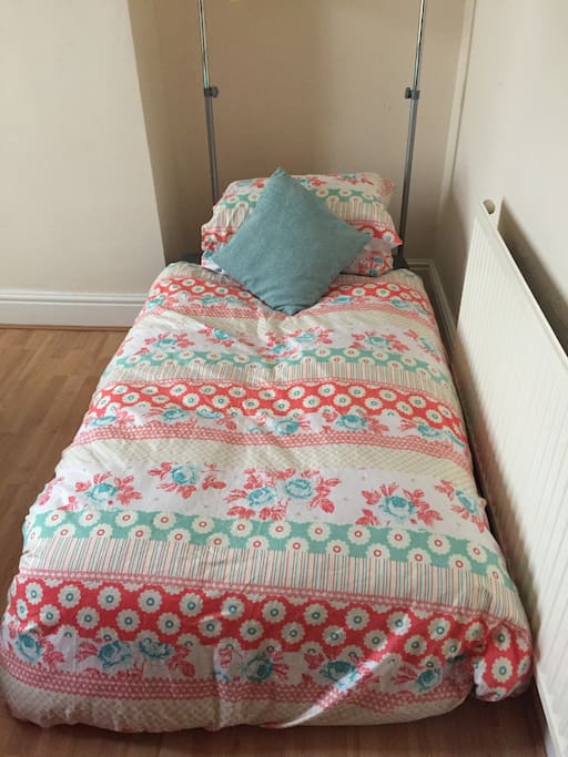 Sofa bed unfolded and made with freshly laundered linen