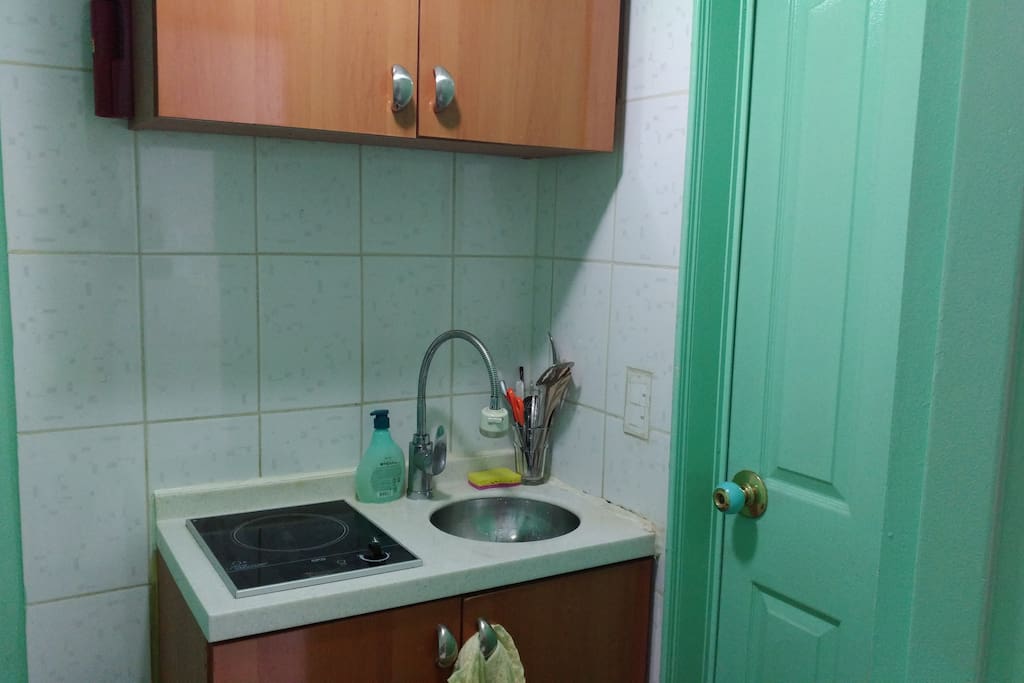 This kitchenette will do the trick for heating up some food (electric stove) and washing dishes.