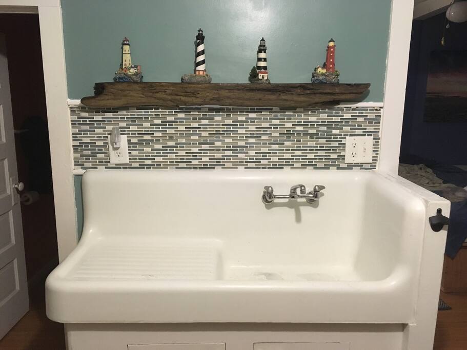 Authentic Oneida Lake driftwood shelf and tile mosaic backsplash w/light under