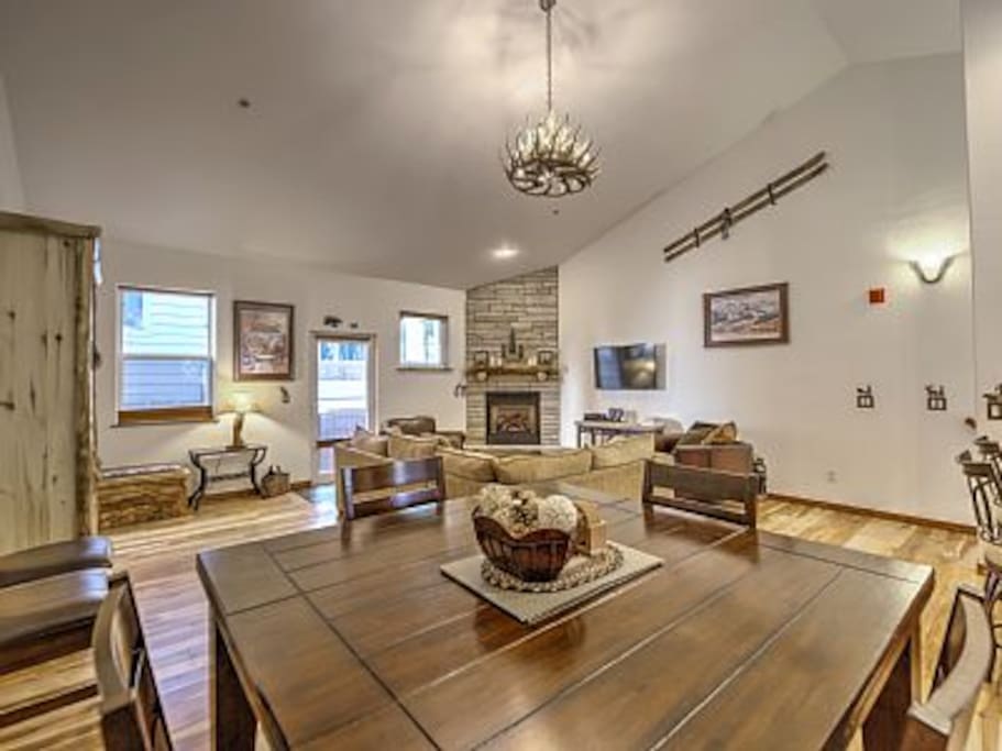 Great Room with stone fireplace, Murphy Bed, and deck.