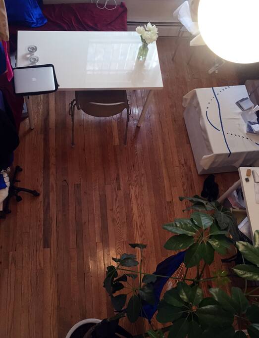 View of downstairs living room/work area from upstairs sleeping loft