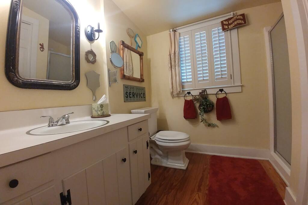 Bathroom offers natural light, ample storage, and beautiful pine floors that are throughout the cottage