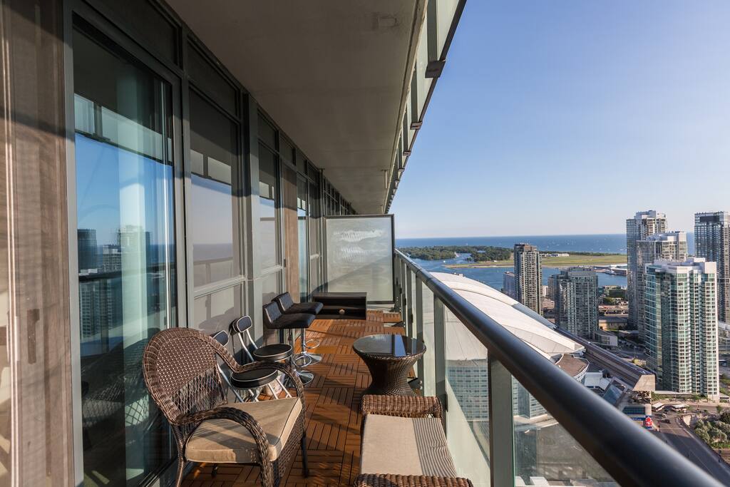 I've done my best to turn the balcony into a relaxing patio where guests can fully enjoy the sunshine and rare lake + city view