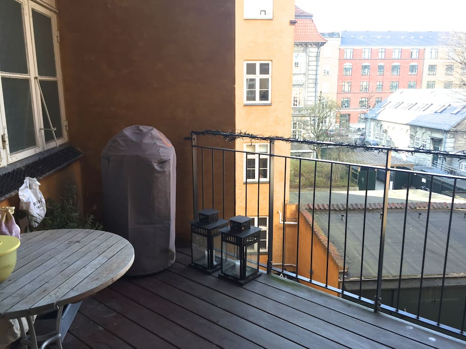 Large balcony with table and chairs