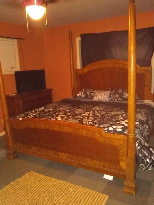 Spacious and comfortable master bedroom with four-poster king-size bed