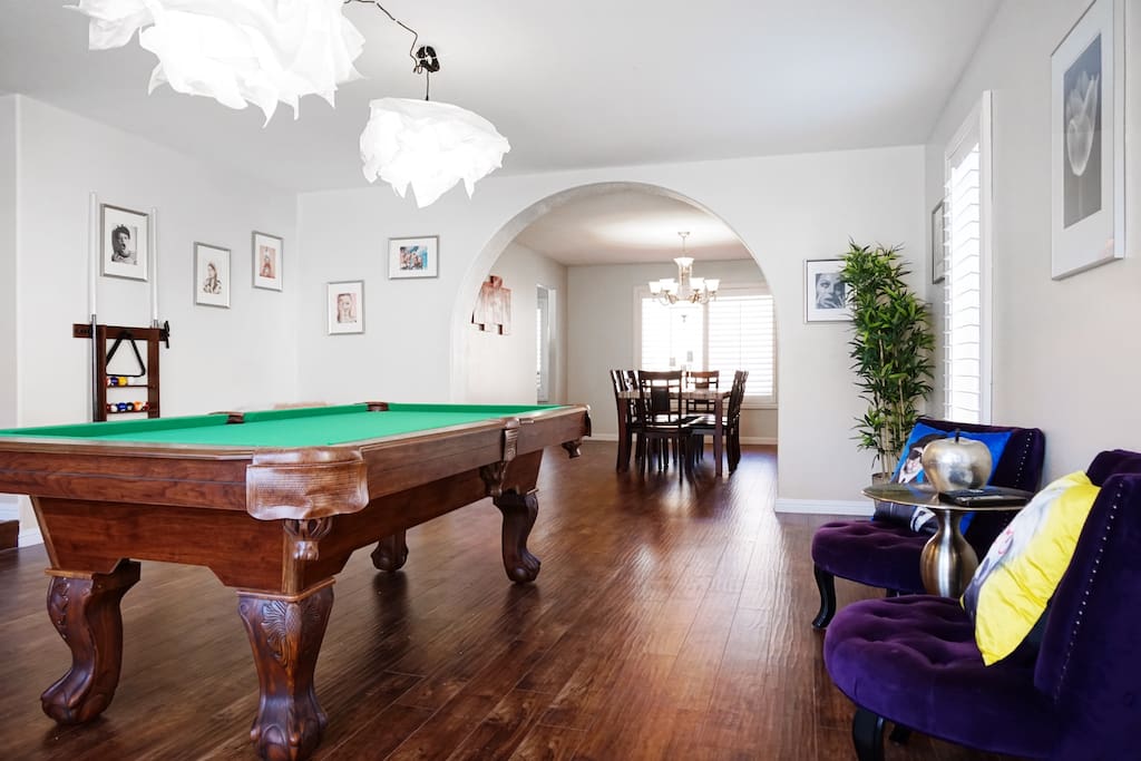 The game room features cool furniture and a pool table
