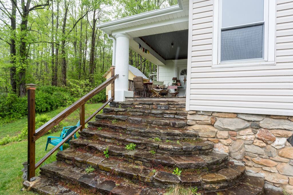 Local river rock steps lead you to the covered front porch with sweeping mountain views.