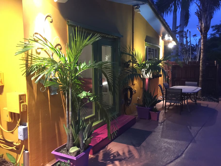 This is the night view of the cottage from the pool. Soft ambient lighting that highlights the lush tropical foliage. The green double doors are where you enter the cottage.