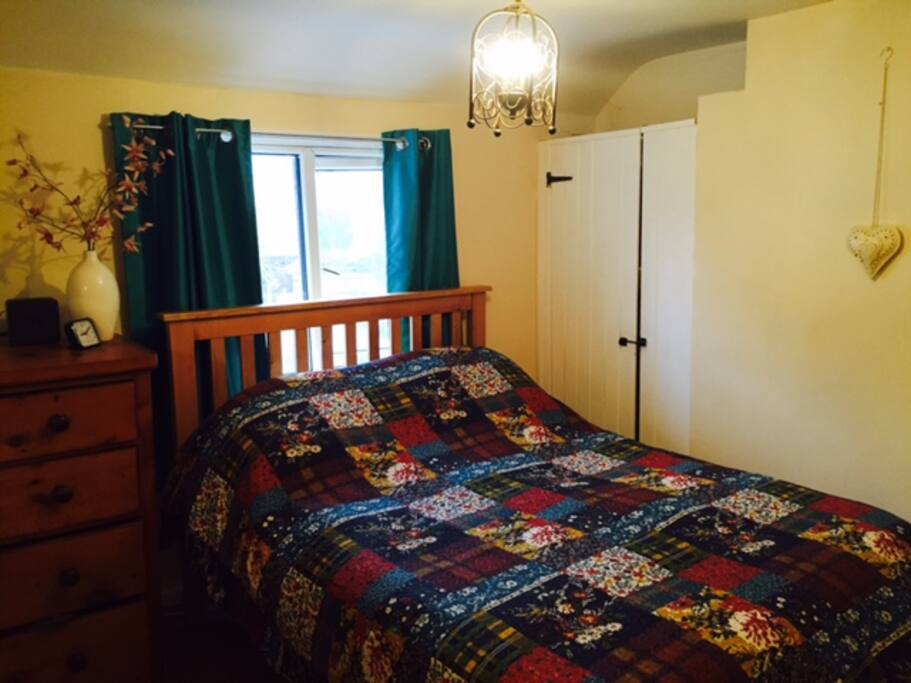 Pretty cosy double bedroom with chest of drawers and built in wardrobe.