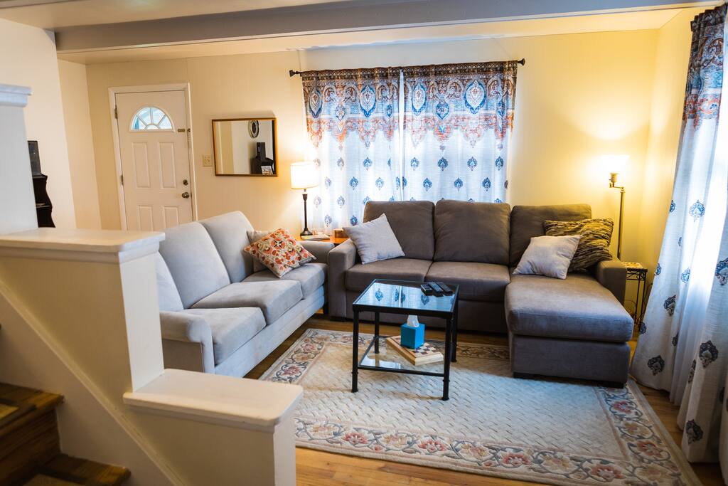 As you walk in the front door, a light, airy and welcoming living room greets you.