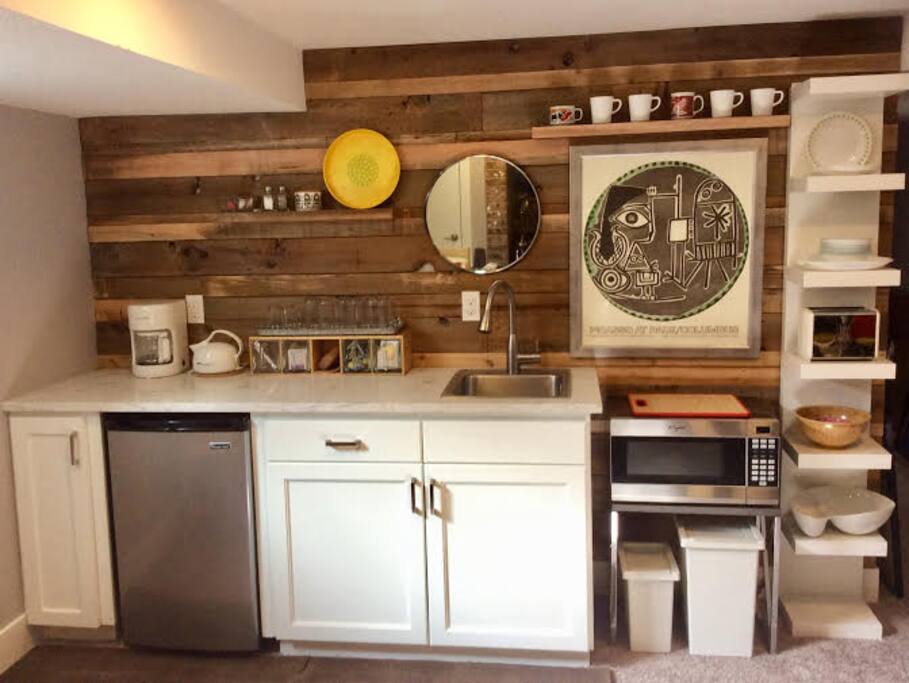 Cute, clean kitchenette with fridge, microwave, toaster, coffee maker, and electric tea kettle.