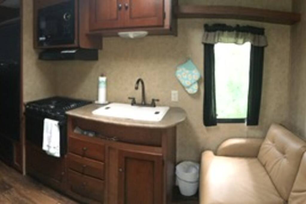 Carla has a neat and clean living area for cooking, relaxing and just enough space!