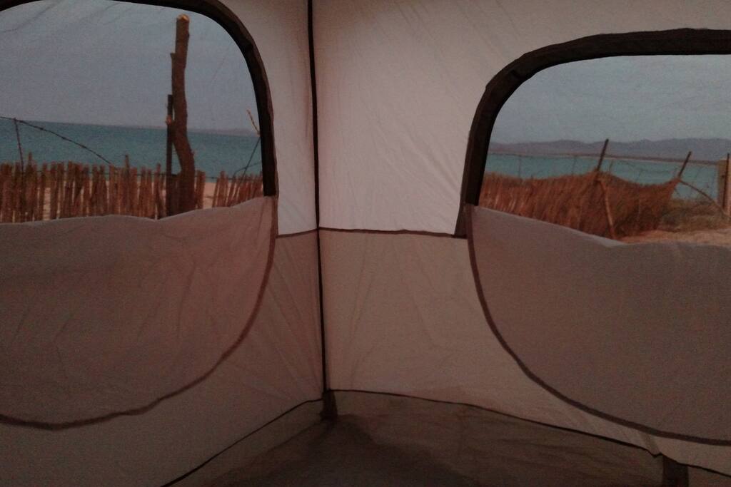 Large windows inside the tent at sunset in December.