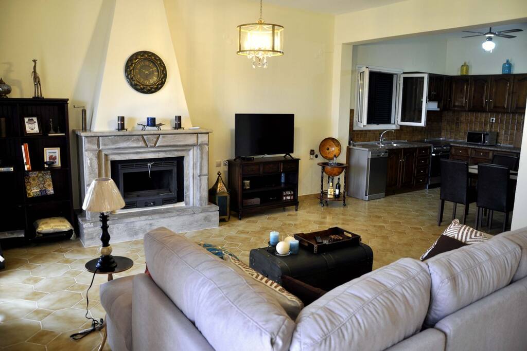 A spacious living room with a connected kitchen